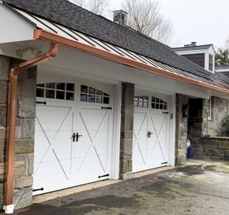 Copper gutters installed above garage